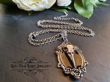 Load image into Gallery viewer, Striking Crow Skull Pendant Necklace - Antiqued Silvertone Finish - Black Enamel Detail - Gothic Modern-Vintage Style