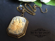 Load image into Gallery viewer, Awaken the Kraken! Actually, maybe don't. That never ends well. Just wear him as an epic fashion accessory instead! This truly stunning contemporary resin cameo is set in a beautiful antiqued bronze-finish base and features a fire polished ocean blue faceted crystal and a tiny scallop shell charm in blackened brass worked into the chain length. The chain itself comes in the three lengths for you to choose from. The pendant itself is sublimely dramatic and measures 7x4cm (70x40mm/2.75x1.57 Inches)