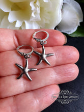 Load image into Gallery viewer, Petite Silvertone Starfish Drop Earrings, Closure, Length: 3.5cm(35mm/1.37 Inches) with hand used for scale.
